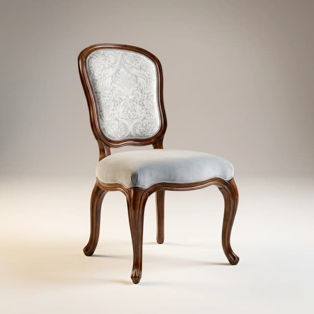 An ornate teak side chair with curved legs and lyre-shaped backrest.