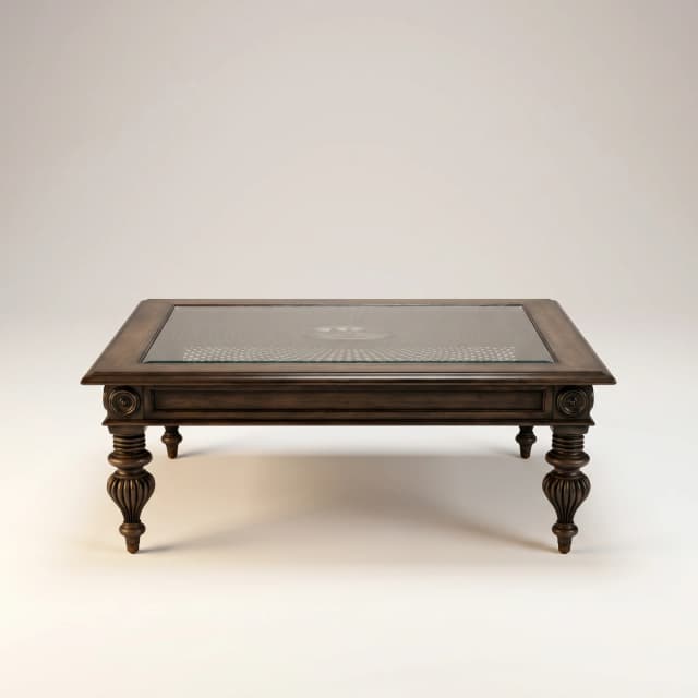 Carved teak wood centre table with intricate Victorian-style carvings showcased against a light neutral backdrop.