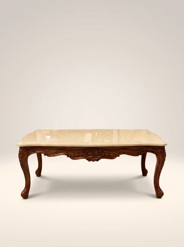 Solid teak carved coffee table with Victoria-style decorative wood carvings, featuring a contrasting cream glossy lacquer finish on the top.