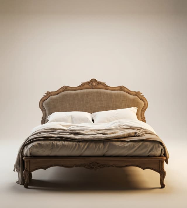 Victorian-style upholstered teak wood bed with intricate carvings and ornate details.
