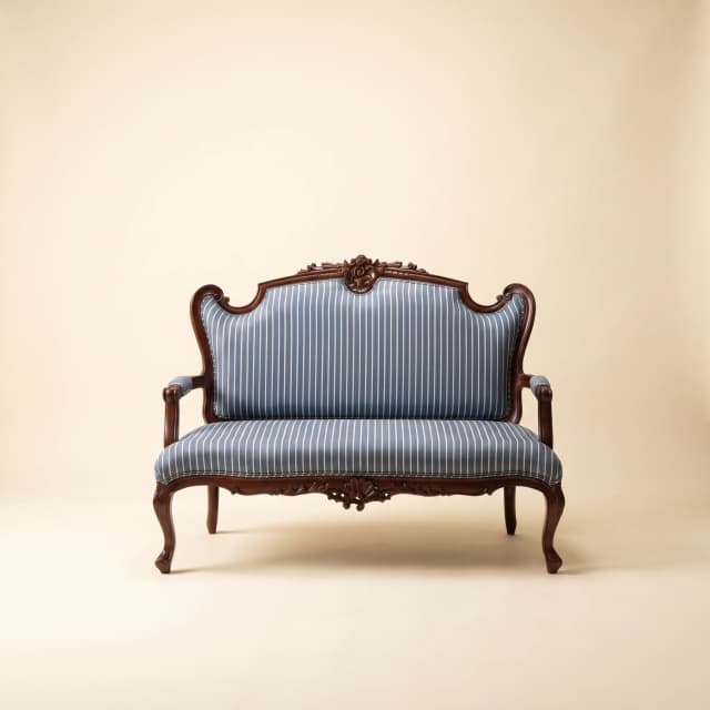 Elegant Azure Victorian-style teak sofa with intricate carvings and a rich heritage.