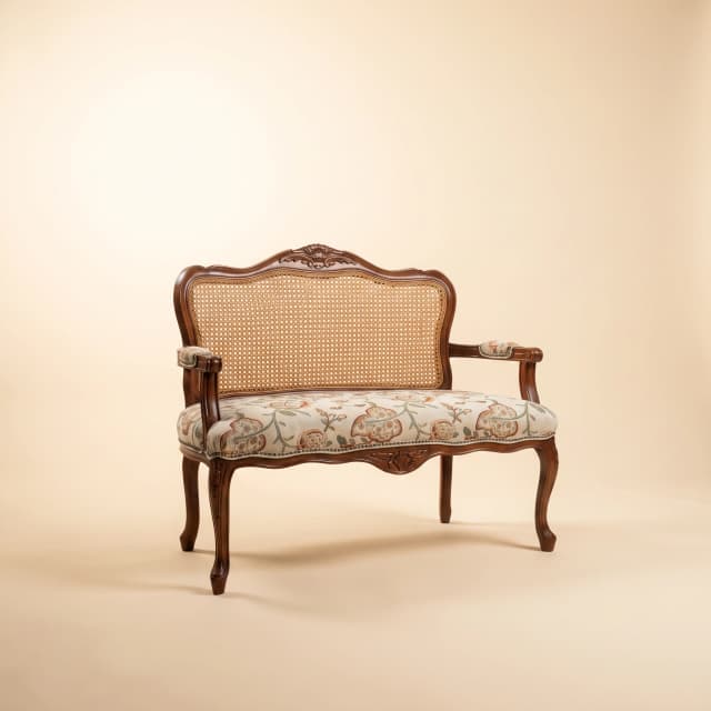 Classic Victorian-inspired teak wood sofa with a natural finish.