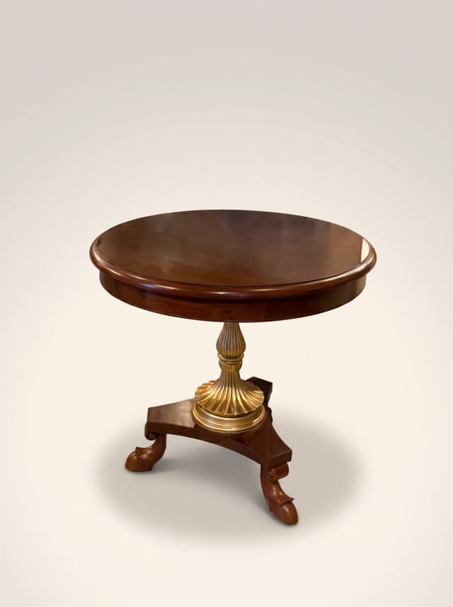 Victorian style teak coffee table with brass accents.